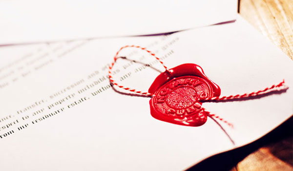 Een document met een rood waszegel en een koord, dat de echtheid en bindende kracht symboliseert.